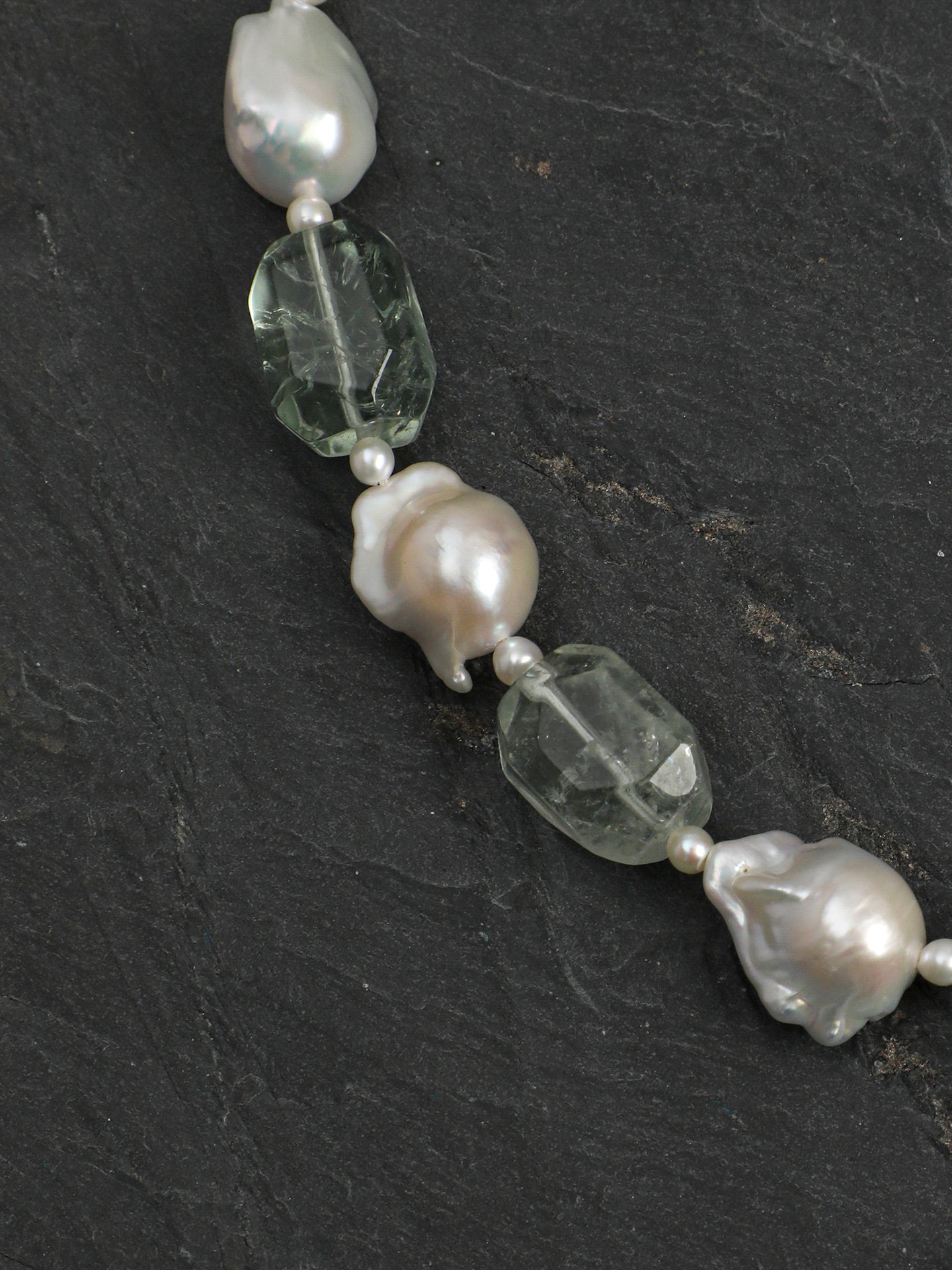 Macro close-up of Natural Green Quartz and Medium Baroque Pearl Necklace,natural gemstone and pearl texture,925 sterling silver fine jewelry,layered necklaces