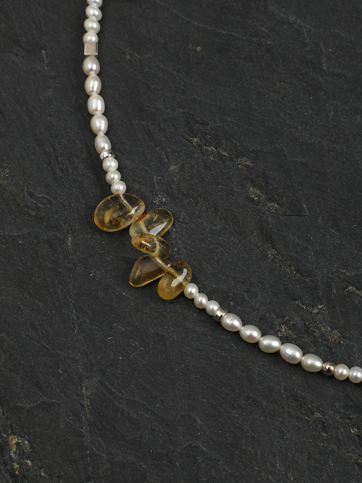 Macro close-up of Natural Citrine Long Points and Freshwater Pearl Necklace,natural gemstone and pearl texture,925 sterling silver fine jewelry ,layered necklaces
