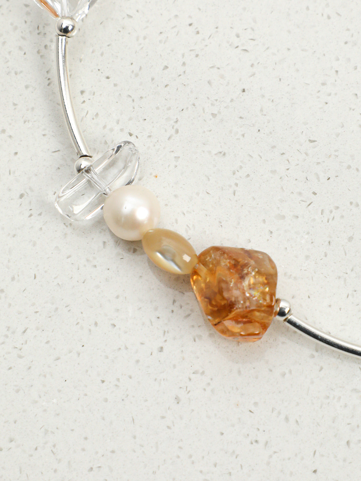 Macro close-up of Citrine and Clear Quartz Silver Tube Necklace,natural gemstone and pearl texture,925 sterling silver fine jewelry