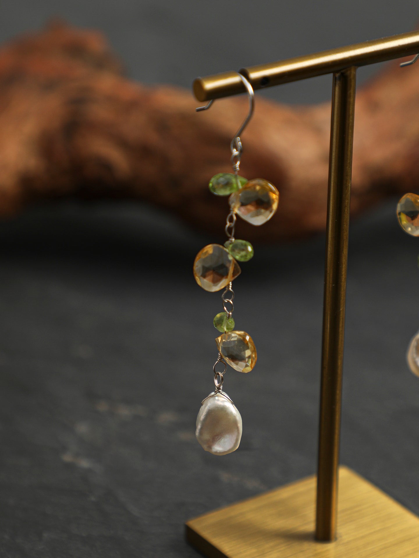 Close-up detail shot of Natural Peridot and Petal Pearl Cascade Earrings,natural gemstone and pearl texture,925 sterling silver fine jewelry 
