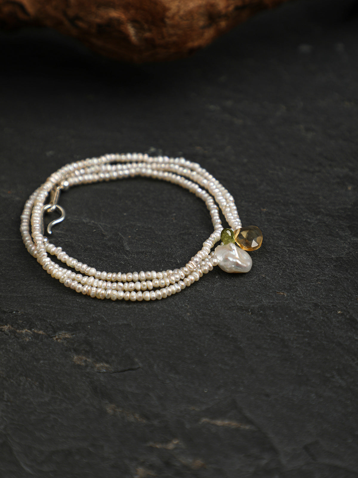 Close-up detail shot of Natural Peridot and Citrine Drop Pearl Necklace,natural gemstone and pearl texture,925 sterling silver fine jewelry,layered necklaces