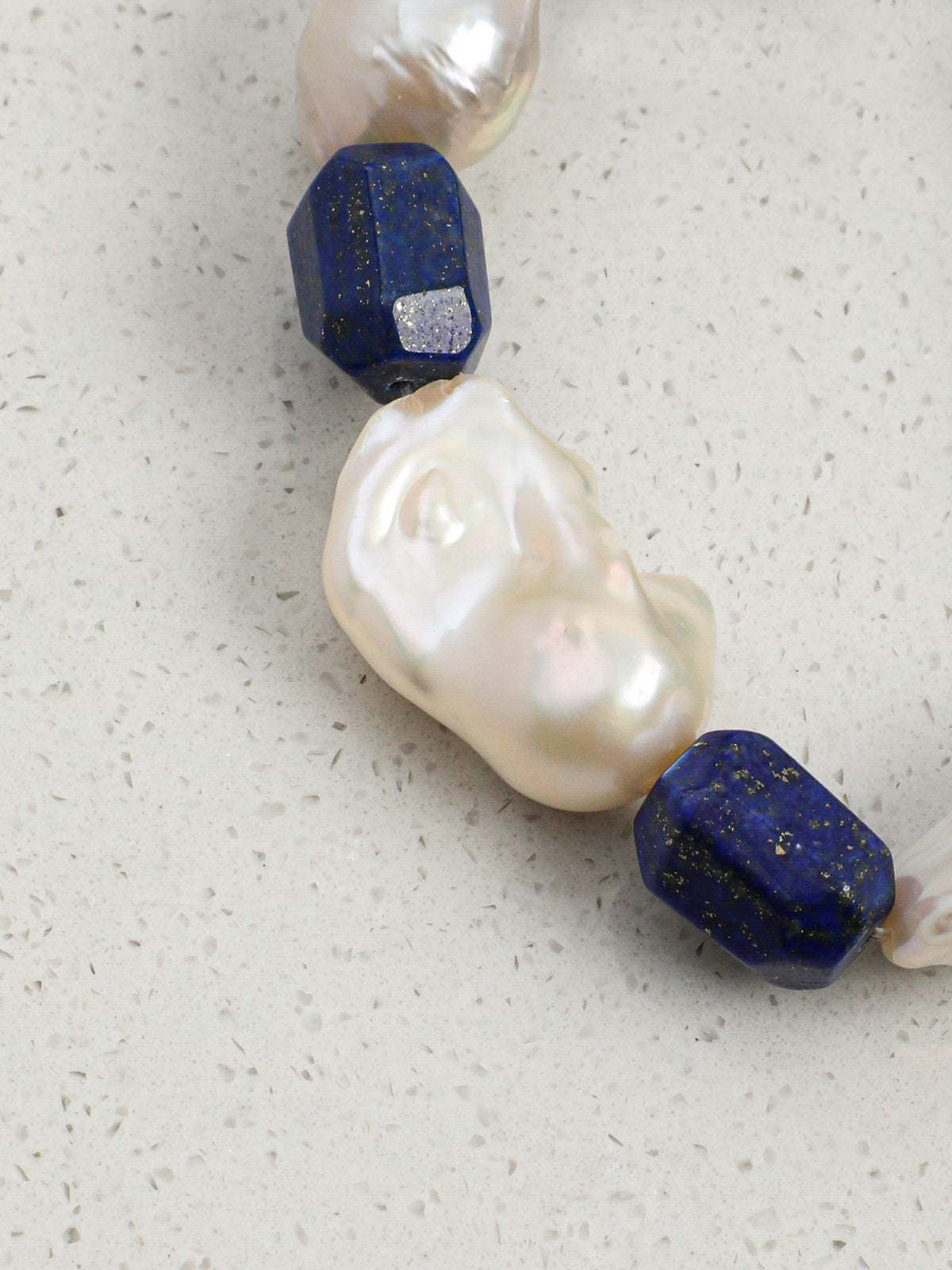 Macro close-up of lustrous irregular chunky baroque pearls showing organic surface texture