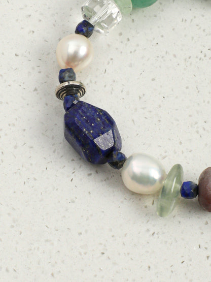 Close-up shot of rich blue lapis lazuli and vibrant green aventurine beads on gemstone bracelet