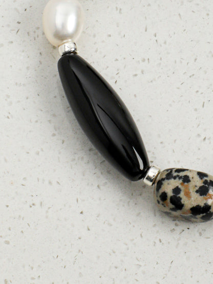 Detail of raw dalmatian stone and black tourmaline crystal bead textures