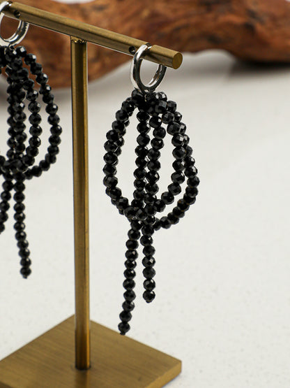 Macro shot of light-catching natural faceted black tourmaline beads