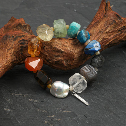 Chunky rainbow natural gemstone and oversized baroque pearl bracelet with S925 silver tag on neutral background