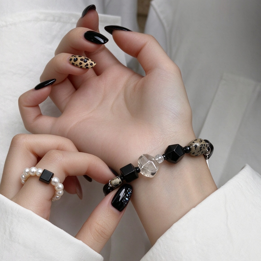 Model wearing black agate and moonstone beaded bracelet on wrist modern jewelry styling